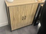 a desk with a cabinet and a chair next to it