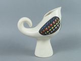 a white vase with a black and red design on it