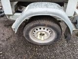 a trailer with a flat tire and a flat bed