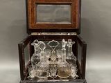an antique glass and wood display case with a mirror on top of it