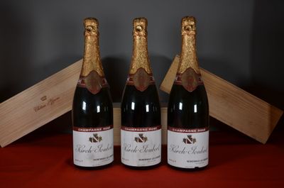 three bottles of wine sitting next to a wooden box on a table
