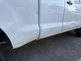 a white truck that is parked on the side of the road