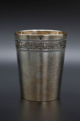 une coupe ancienne en argent ornée d'un motif sur le bord