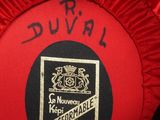 a close up of a red hat with a black label on it