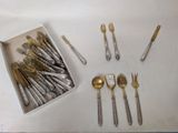 a box of silverware on a table with other silverware in it