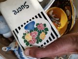 a person holding a carton of milk in a box