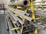 a large pile of steel pipes in a warehouse
