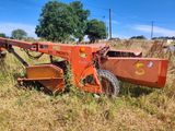 a tractor that is sitting in the grass