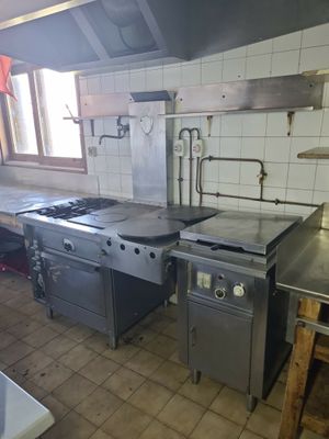 une cuisine équipée d'une cuisinière, d'un four et d'un évier