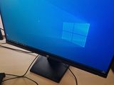 a computer monitor sitting on a desk with a mouse