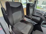 a picture of the inside of a bus with the driver ' s seat up