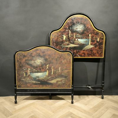 pair of painted headboards with candles on them on a wooden floor
