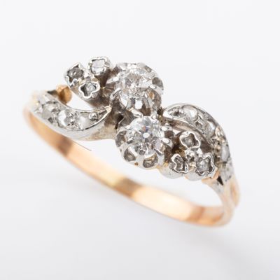 a close up of a gold and diamond ring on a white background