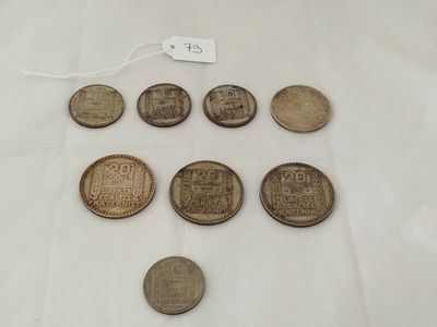 six different types of coins on a table with a price tag