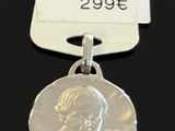 a close up of a silver medal with a tag on it