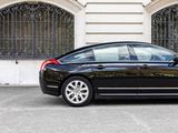 a black car that is parked in front of a building