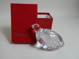 a red box with a glass perfume bottle in it