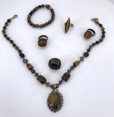 a necklace, bracelet, and ring set on a table