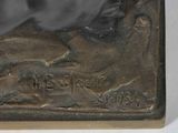 bronze statue of a man and a dog on a rock