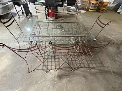 a glass table and four chairs in a room