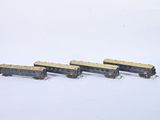 four toy trains that are sitting on a white surface
