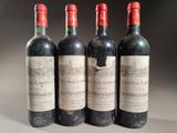 three bottles of red wine are lined up on a table
