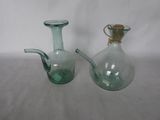 deux vases en verre vert posés l'un à côté de l'autre sur une table