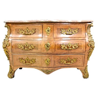 a wooden chest of drawers with gold decorations on it