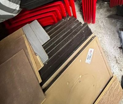 une pile de chaises rouges dans une pièce où se trouve un radiateur rouge