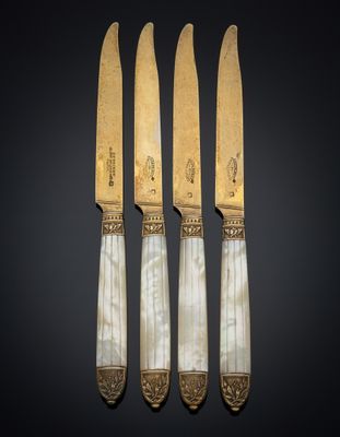 three knives and a knife holder on a black background