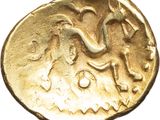 an ancient gold coin with an image of a man riding a horse