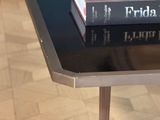 a stack of books sitting on top of a coffee table