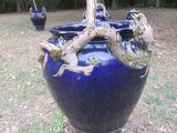 a large blue vase with a dragon on it in the grass