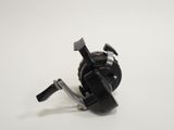 a close up of a fishing reel on a white surface