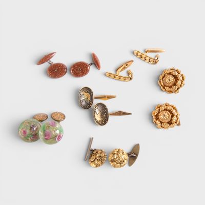 several pairs of earrings are arranged in a circle on a white surface