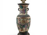 a large vase with a lamp on top of it