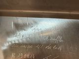 a close up of a metal plate with writing on it