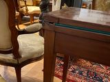 a table and chairs in a room with a rug on the floor