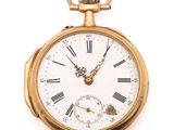 a gold pocket watch with roman numerals on the face