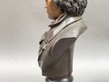 two bronze busts of a man and a woman sitting side by side