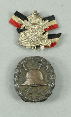 two medals and a medal on a white surface