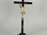 a black and gold crucif with jesus on the cross