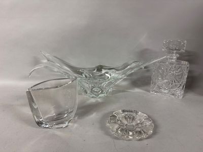 a glass bowl and a glass decanter sitting on a table