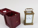 two miniature clocks sitting next to each other on a table