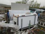 a refrigerator that is sitting in the back of a truck