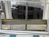 a window that has a wooden bench in front of it