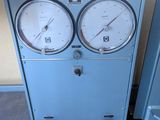 two gauges on the side of a blue cabinet
