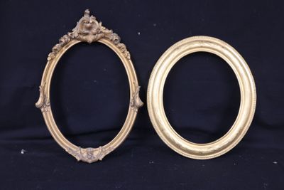two gold oval frames with ornate designs on a black background
