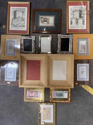 a lot of framed pictures on the wall in this room