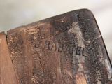 a close up of a piece of wood with writing on it